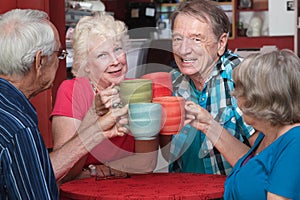 Senior Adults Toasting with Mugs
