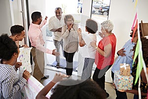 Senior African American  couple arriving home to a family surprise party, elevated view