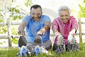 Senior African American Couple Exercising In Park