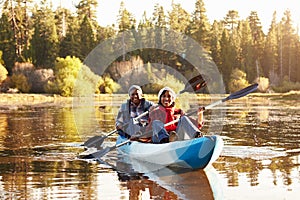 Senior African American Couple Rowing Kayak On Lake