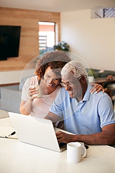 Senior African American Couple Using Laptop To Check Finances At Home