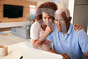 Senior African American Couple Using Laptop To Check Finances At Home