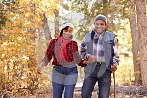 Senior African American Couple Walking Through Fall Woodland