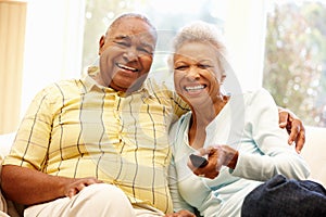 Senior African American couple watching TV