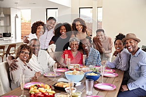 Senior African American  couples sitting at dinner table celebrating at home with family,selective focus
