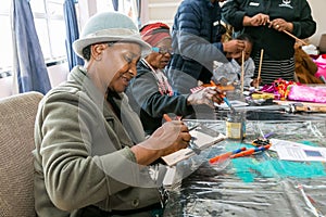Senior African American female doing arts and crafts at an event