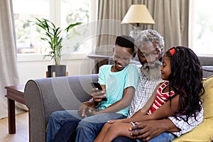 Senior African American man and his grandchildren enjoying their time at home