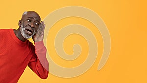 A senior African American man wearing a red sweater and a concerned expression