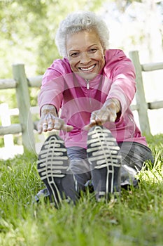 Senior African American Woman Exercising In Park