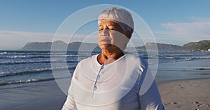 Senior african american woman walking and relaxing at the beach