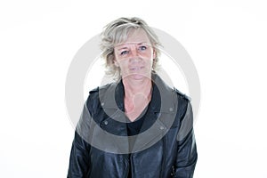 Senior aged woman in her 60s biker with a black leather perfecto jacket on a white background photo