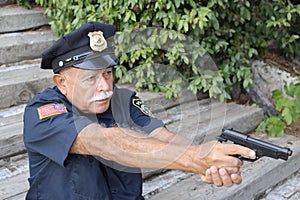 Senior American police pointing with a gun