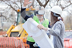 Senior architect or businessman using virtual reality goggles on a construction site