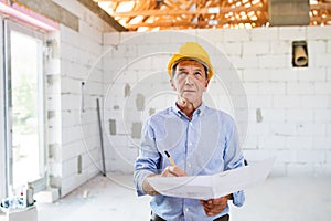Senior architect or civil engineer at the construction site.