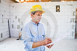 Senior architect or civil engineer at the construction site.