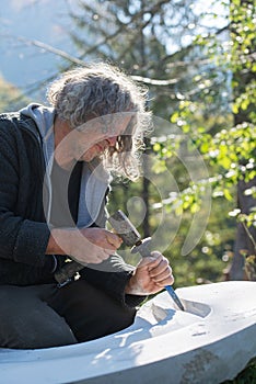 Senior artist carving in stone