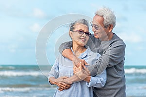 Senior asia couple relaxing by the sea on sunny day