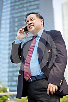 Senior Asian businessman using smart phone