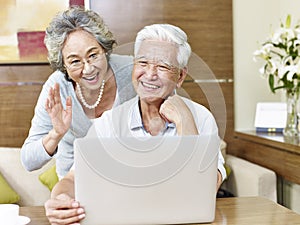 Senior asian couple chatting online photo