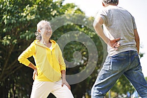 Senior asian couple exercising in park