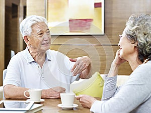 Senior asian couple having a conversation at home