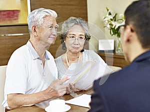 Senior asian couple meeting a sales rep