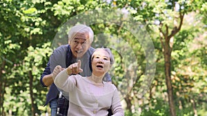 Senior asian couple relaxing outdoors in park