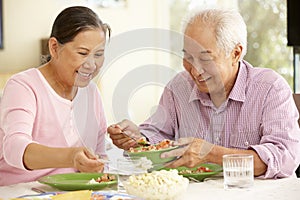 Senior asian couple sharing meal at home