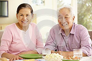 Senior asian couple sharing meal at home