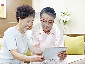 Senior asian couple using tablet computer together