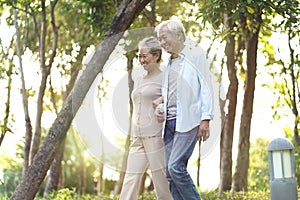 Senior asian couple walking in park