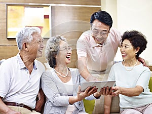 Senior asian couples using tablet computer