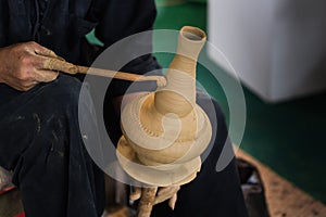 Senior asian handcraft potter making clay pot