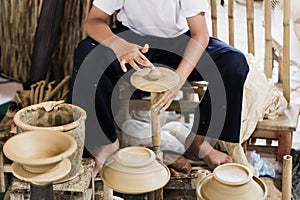 Senior asian handcraft potter making clay pot