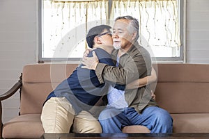 Senior Asian man embracing and listening to bad news from his son who just lost a job and come back home seeking for consolation