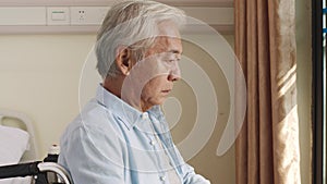 Senior asian man sitting alone in wheelchair