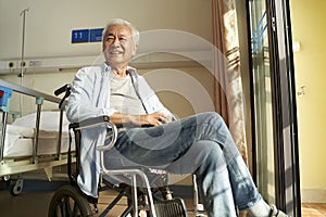 Senior asian man sitting in wheel chair in nursing home