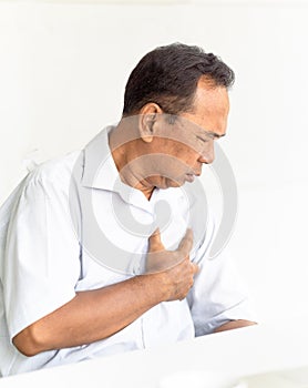 Senior asian man suffering in chest pain.