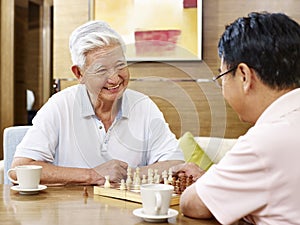 Senior asian men playing chess