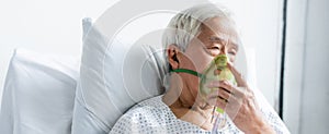 Senior asian patient in oxygen mask