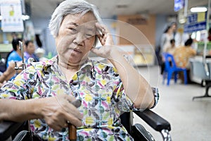 Senior asian patient in wheelchair waiting for a long time,medical examination with the doctor in the hospital,elderly people feel