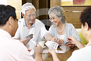 Senior asian people playing cards
