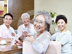 Senior asian woman in card game