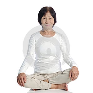 Senior asian woman doing meditation in buddhism pr