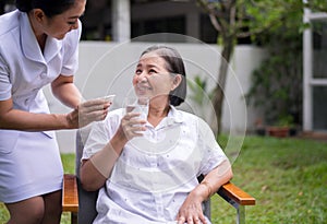 Senior asian woman hands holding a glass of water,Nursing home care concept