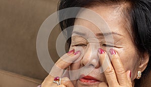 Senior asian woman has eyestrain and fatigue