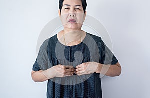 Senior asian woman having or symptomatic reflux acids,Gastroesophageal reflux disease,Copy space on white background