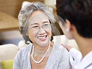 Senior asian woman talking to a doctor