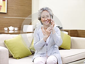 Senior asian woman using cellphone