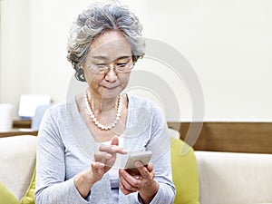 Senior asian woman using mobile phone